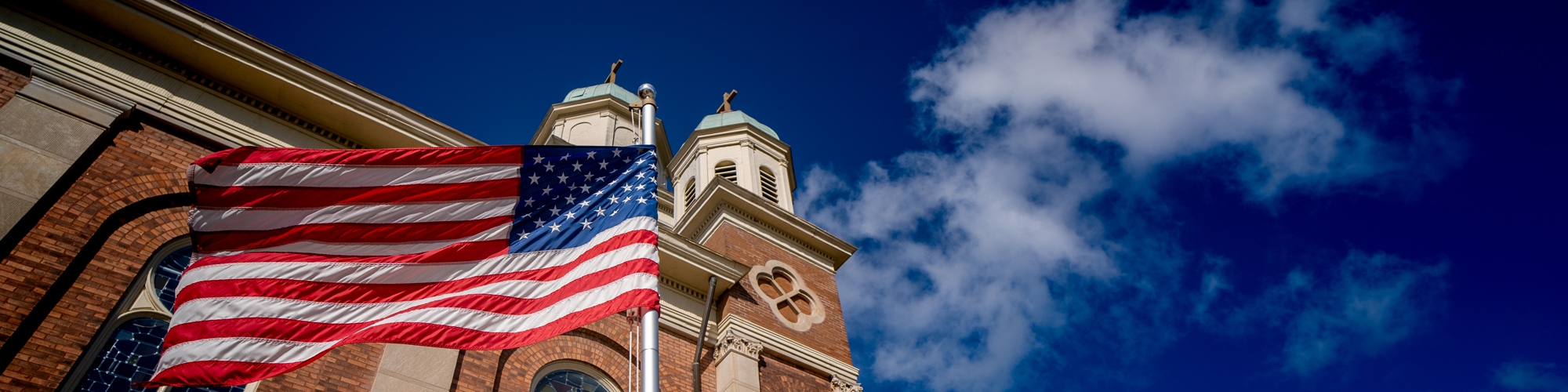 American flag waving on the side of the Church